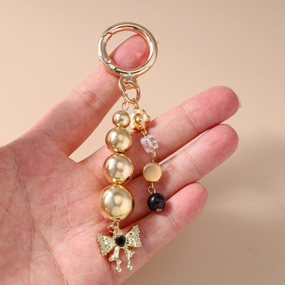 Porte - clé Perle <br> Le Papillon doré - Or et noir