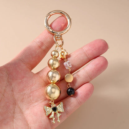 Porte - clé Perle <br> Le Papillon doré - Or et noir