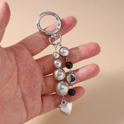 Porte - clé Perle <br> L’Harmonie argentée - Noir et argent